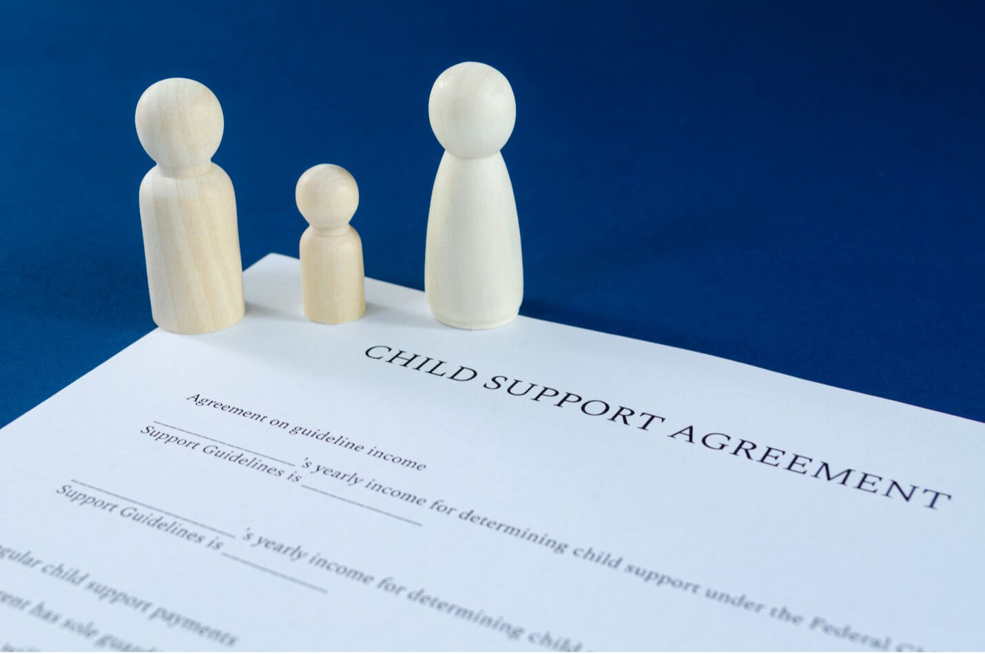 chess pawn pieces on top on child support documents