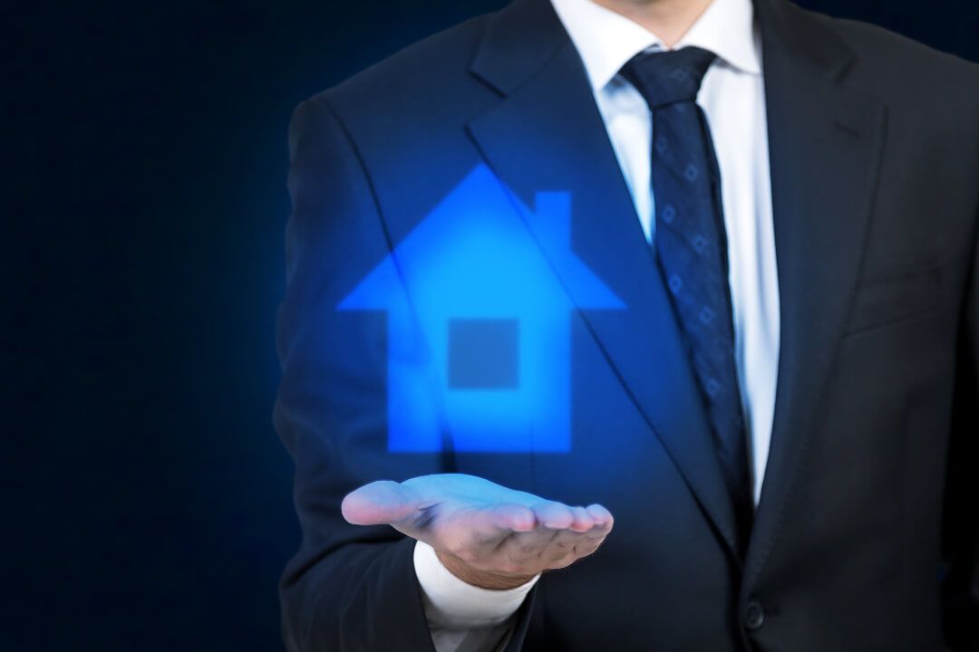 Man in a suit holding out his hand with a blue icon of a house above it