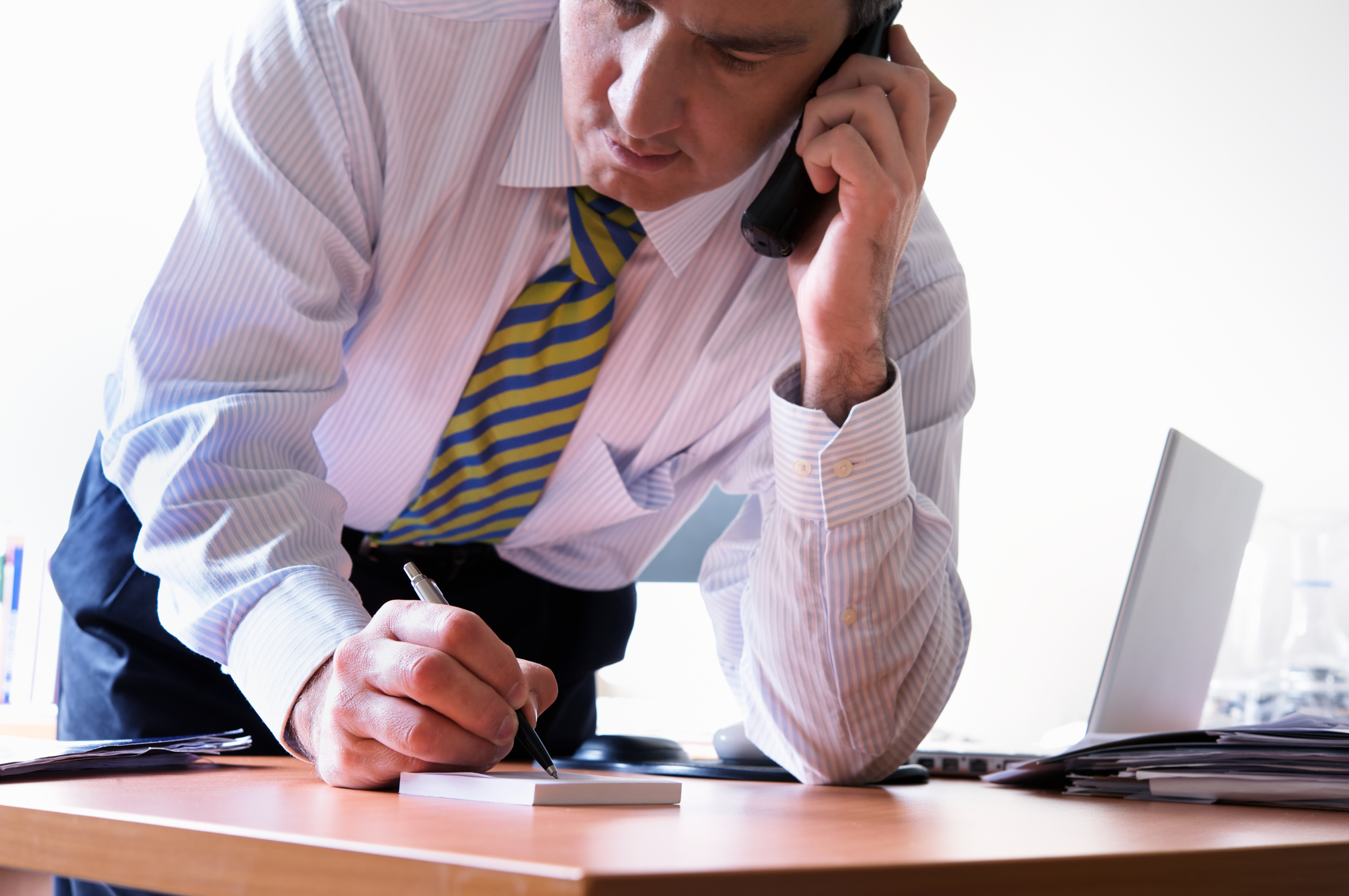 A lawyer multitasking while talking on the phone with a client | EasySoft Legal Software